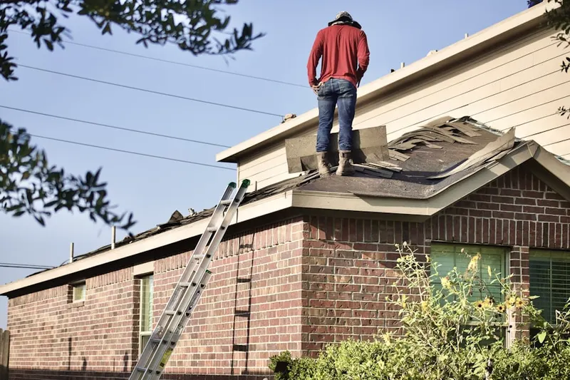Professional roofer working on a residential roof in Toccoa